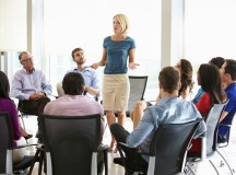 Businesswoman Addressing Multi-Cultural Office Staff Meeting